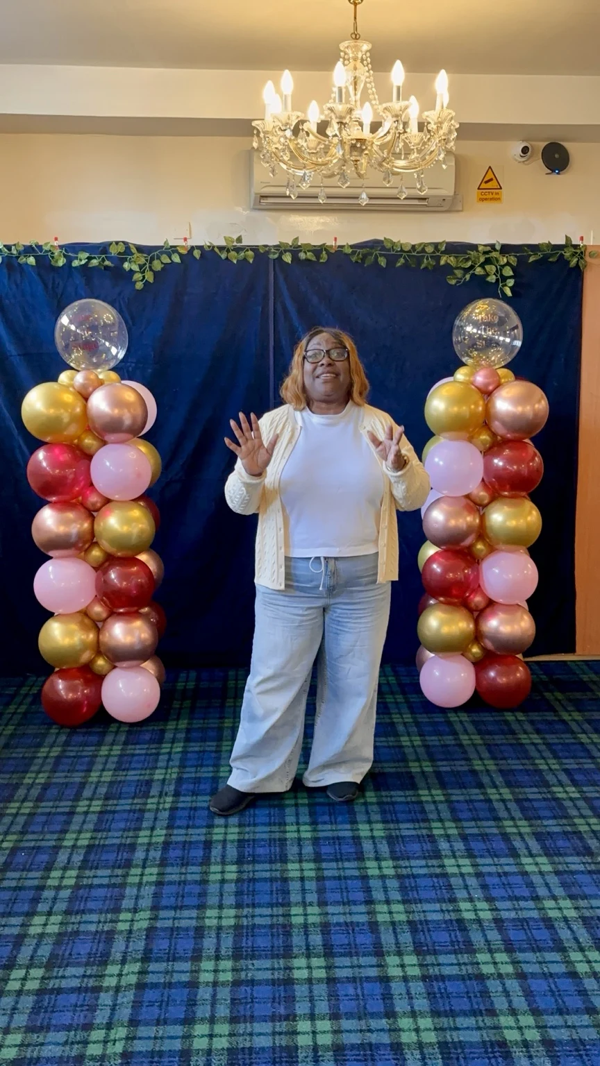Charmaine speaking with her hands raised at Take the Stage training