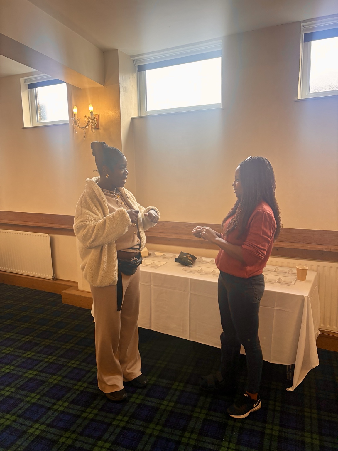 Two participants smiling and responding to each other during a paired activity