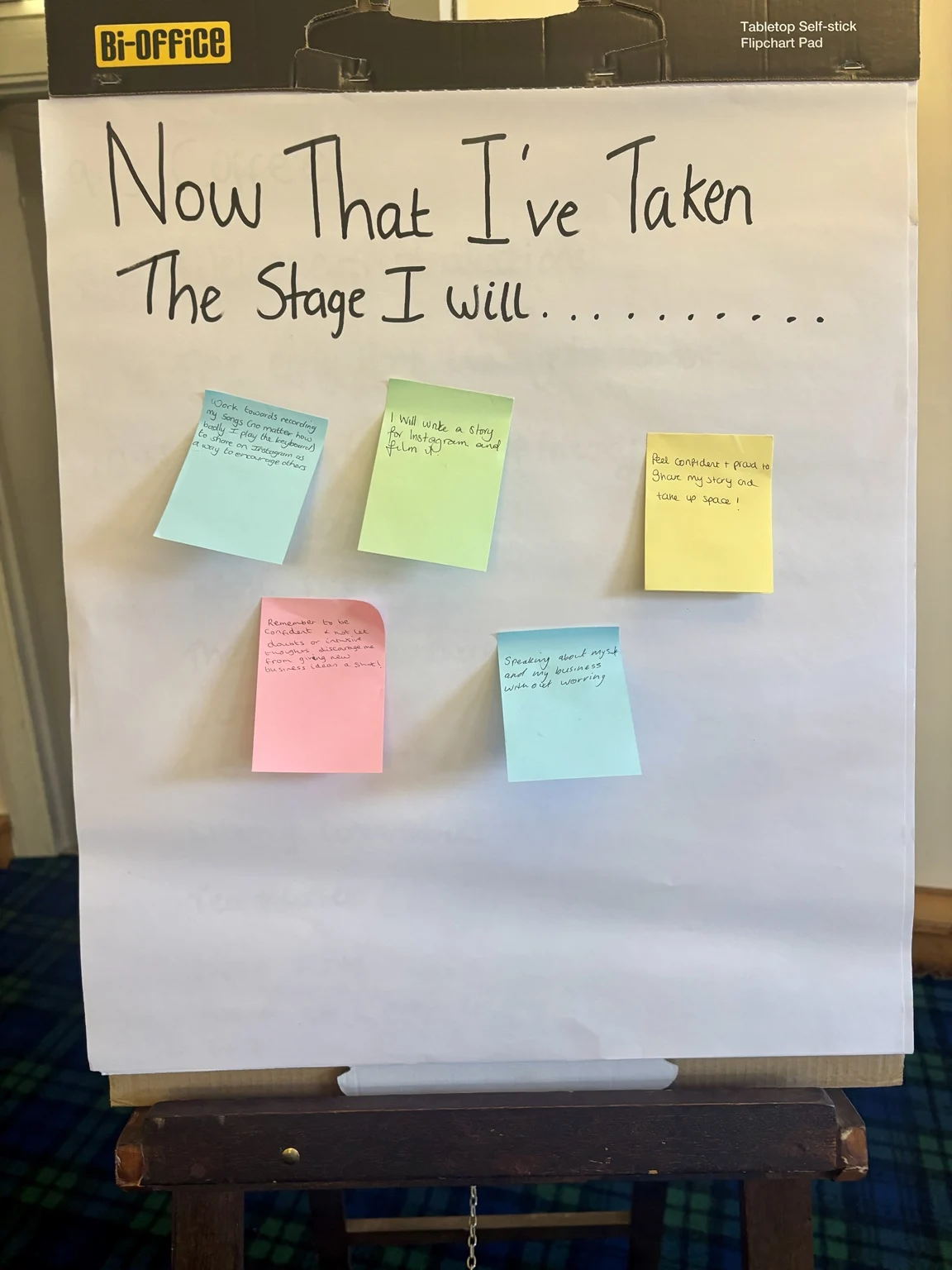 Training reflection board headed ‘Now That I’ve Taken The Stage I Will…’ with participants’ handwritten next steps